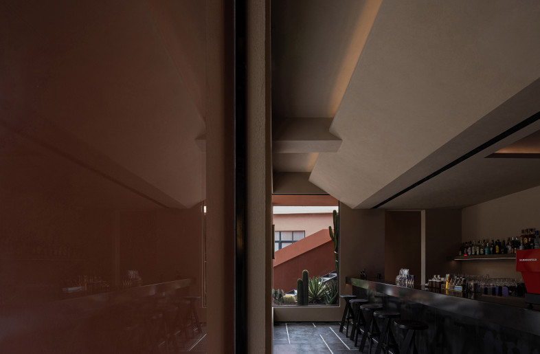 Bar: Arranged linear lamps and projection lamps are embedded in the bevels and hollows at the ceiling, blocking part of the light. The faint light diffuses in the air, enclosing a sense of detachment from the space. - Yun Ouyang