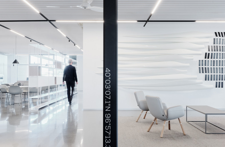 The workstations, furniture and functions in the space exist regardless of the position of the columns, which gently trace a path through them. The columns serve as signposts drawing the eye onwards as they traverse, turn corners, vanish behind a partition, and then reappear on its other side, playfully revealing the position of the next column. - Joe Fletcher