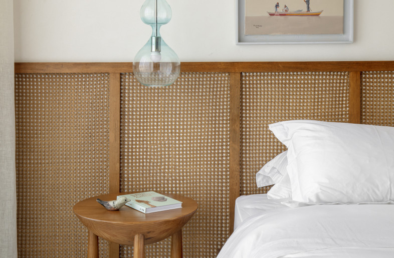 Custom cane headboard and in house designed side tables with a softly rounded body and legs. - Louay Nasser