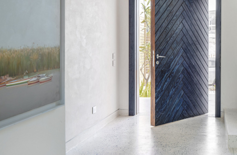 Blue herringbone wood pattern was chosen for the main pivot door and the walls are finished using the age-old Alexandrian Dahara technique. - Louay Nasser