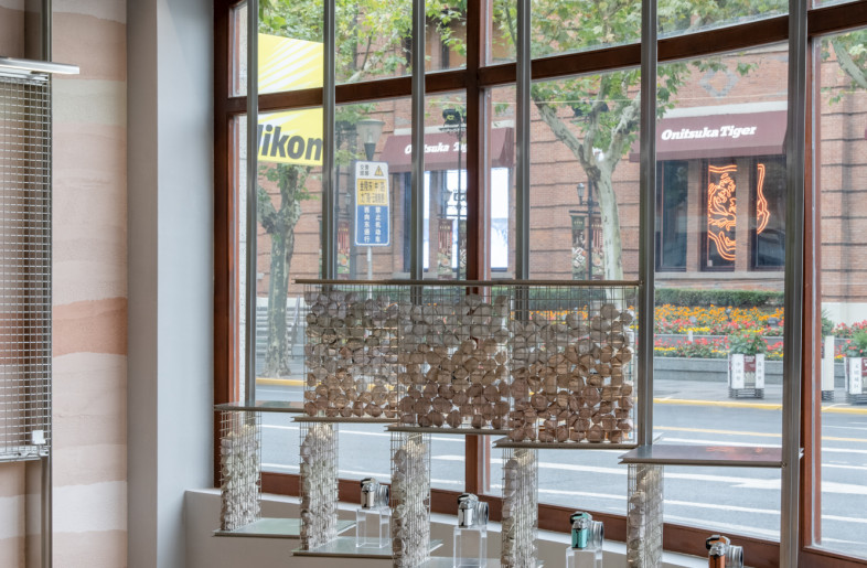 a modular display system staggering along the curved street window - Wen Studio