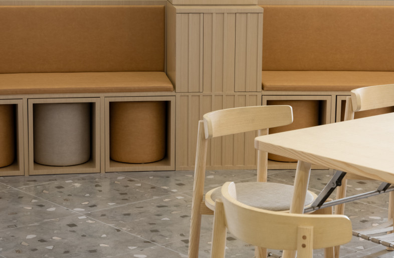leather poufs and wooden stools can be stored snugly under the banquette - Wen Studio