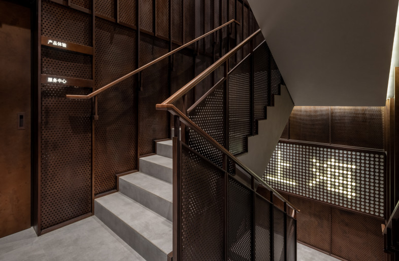 dark perforated walls accentuate the industrial feel - Wen Studio