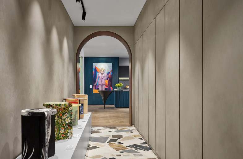 Lining the entrance corridor is a stool showcase that serves as a fundraising collaboration with local art institute, Nanyang Academy of Fine Arts. - Owen Raggett