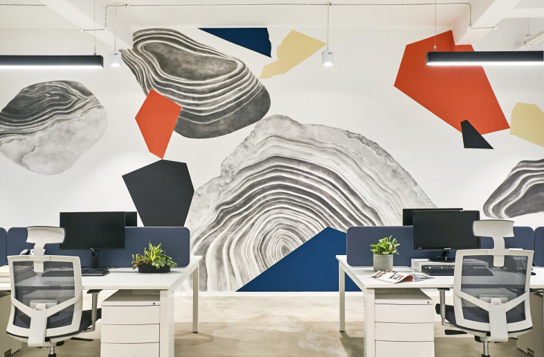 The main office area features a mural by local artist Aeropalmics, who provided a contemporary take on Clarke Quay’s iconic riverside seating with colours of bumboats that drift through the Singapore River. - Justin Loh