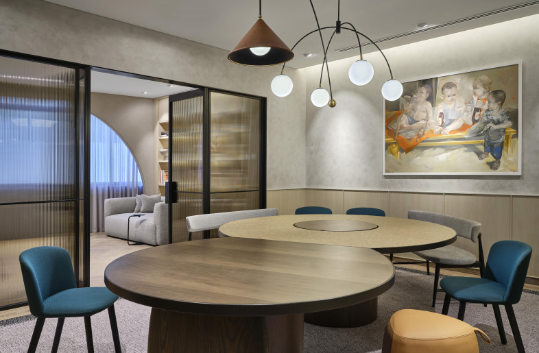 What would otherwise be a serious Meeting Room is adorned with bright furniture, an organic-shaped table and a playful piece of artwork. - Owen Raggett