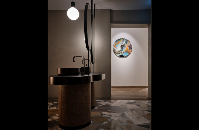 The Unisex Washroom works with a darker and more moody colour scheme, with contrasting materials of polished metal and terrazzo flooring. - Owen Raggett