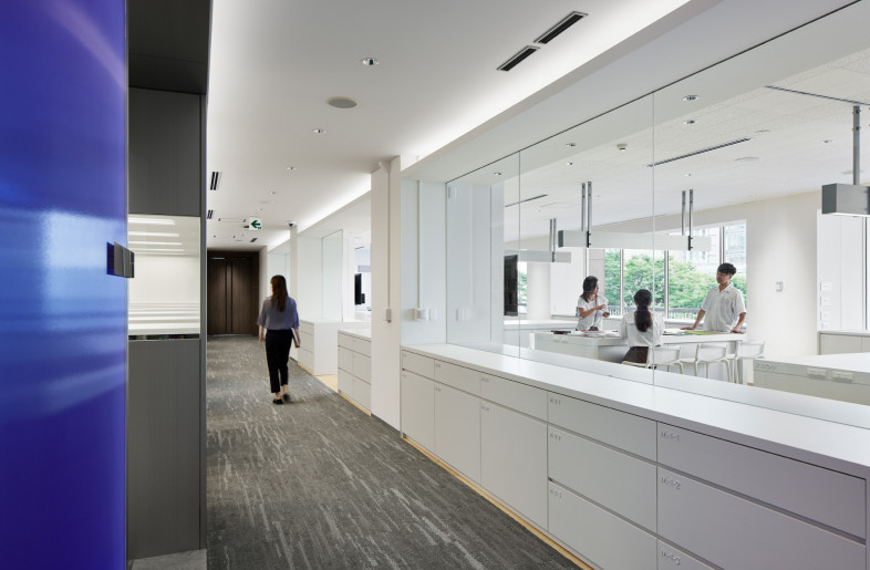 The Studio where creative collaboration takes place, was designed to "Visualize the  quantity of energy produced by creativity from scratch." Catalogs, material samples and peoples working in the room bring colors into this white based minimal space. Through the glass partition wall, guests can experience the process of design being developed in the room. - STUDIO