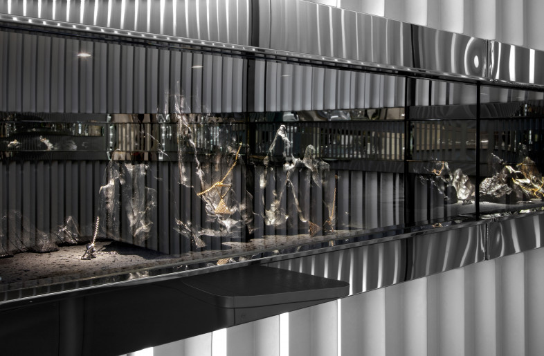 One-way mirrors revealing the jewelry as customer walks closer (on) - Alan Chan Design Company