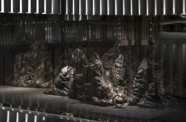 Jewellery display on Chinese scholar stone which represents a microcosm of the universe - Alan Chan Design Company