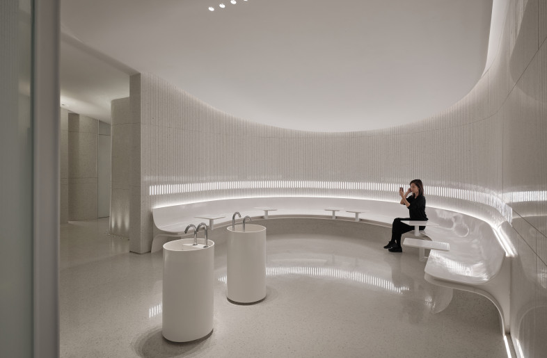 Using a simple design technique to represent the entire space, the white colour on various materials form an arc-shaped public area of female washroom - Jonathan Leijonhufvud Architectural Photography