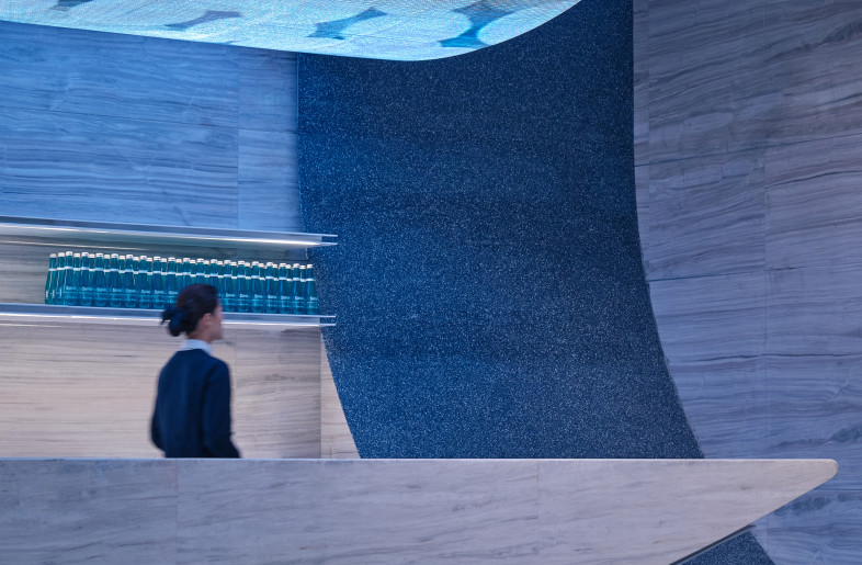 Using stone as the main material for the curved counter on the ground. This make the structure safer, but also enables the transition from light visual perception to a stable functional focal point. - Jonathan Leijonhufvud Architectural Photography