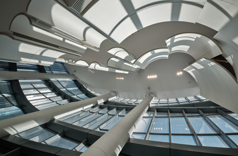 Matt white is the main color for this project. We chose this color because the glass curtain walls on the front of the theatre can transmit natural light very well. - Jonathan Leijonhufvud Architectural Photography