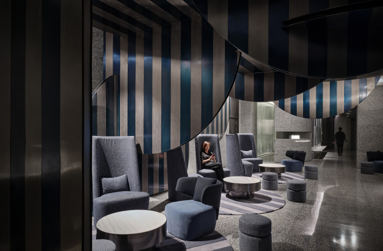 We use round metal sheets that are interspersed in a vertical and horizontal manner to form the overall space. They layered and stacked on top of each other to enhance the interior space. Blue and white colors are used throughout the areas as a unified concept. - Jonathan Leijonhufvud Architectural Photography