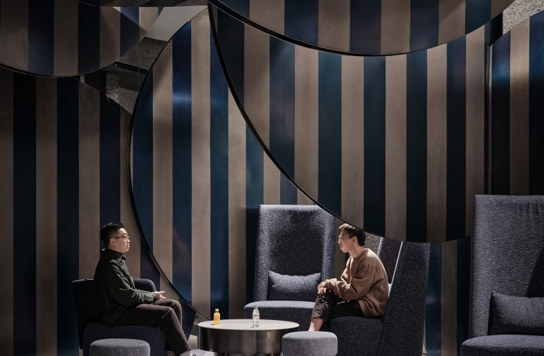 We use round metal sheets that are interspersed in a vertical and horizontal manner to form the overall space. They layered and stacked on top of each other to enhance the interior space. Blue and white colors are used throughout the areas as a unified concept. - Jonathan Leijonhufvud Architectural Photography