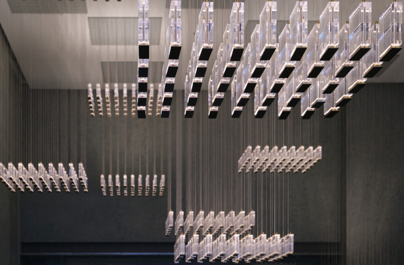 Entering the hall of the cinema, we designed the same custom lamps in the style of hanging chandeliers. Groups of chandeliers were installed from the ceiling, making the lobby space no longer monotonous. They also highlight the originally tall ceiling of the space. - Jonathan Leijonhufvud Architectural Photography