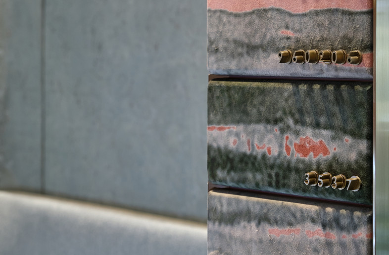 Assigning each safe box a unique number at the lower right corner of the printed fabrics on the wall, each representing a date or a homophony of love. - Jonathan Leijonhufvud Architectural Photography