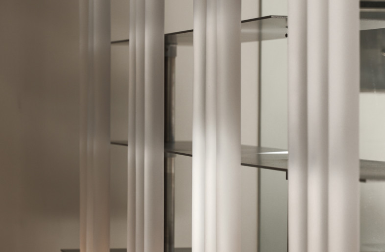 Light passes through the matte acrylic tubes which are integrated with the metal shelvings - Timmy Lo