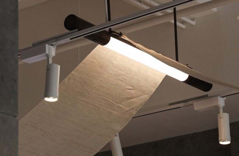 A long piece of Korean Ramie fabric is draped on the wood-beam-like pendant lamps to echo with a traditional Hanok roof - Timmy Lo