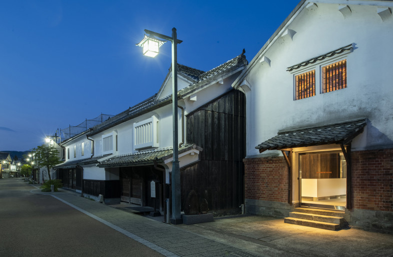 The image of the warehouse located. This area has been designated as a national preservation area for a group of traditional buildings. The area is lined with townhouses with exterior walls covered with white plaster, creating a landscape full of historical sentiment. - Hiroshi Mizusaki