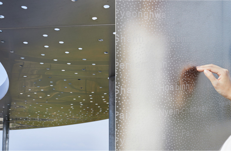 The monument's ceiling and central column are decorated with many circles drawn by people. - Nacasa ＆ Partners Inc. | Akira Arai