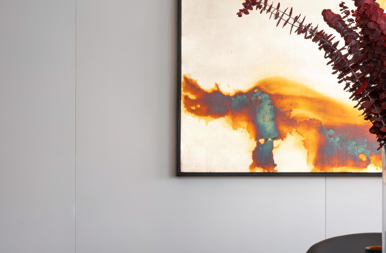 A collection of contemporary art including an oxidised silver leaf painting with burned wood tones by artist Tata Montilla adds drama to the room. - Mr. Edmon Leong