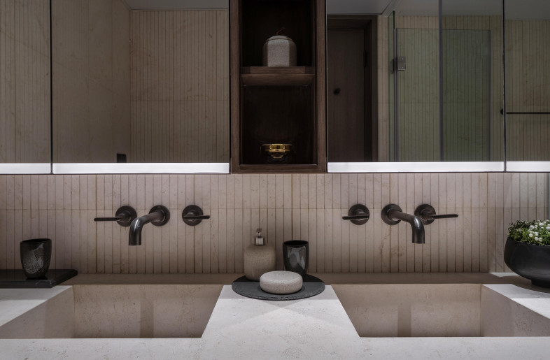 In the master bath, which features sleek Salvatori sandstone paired with brushed black Gessi fittings creating a minimalist, spa-like environment. - Mr. Edmon Leong