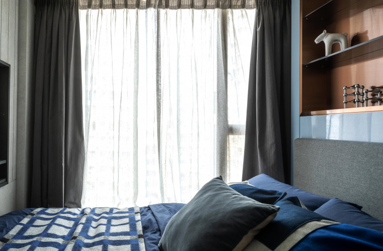 Son's bedroom features a dark blue and concrete grey colour palette with copper accents. - Mr. Edmon Leong