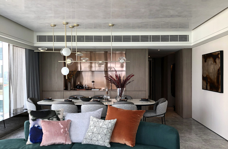 A chandelier by Ross Gardem featuring textured mouth-blown glass pieces, inspired by ripples in the ocean, anchors the space. - Mr. Edmon Leong