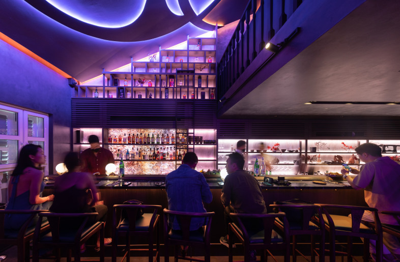 The bar was transformed into two distinct areas using light and custom shelving. - Finbarr Fallon