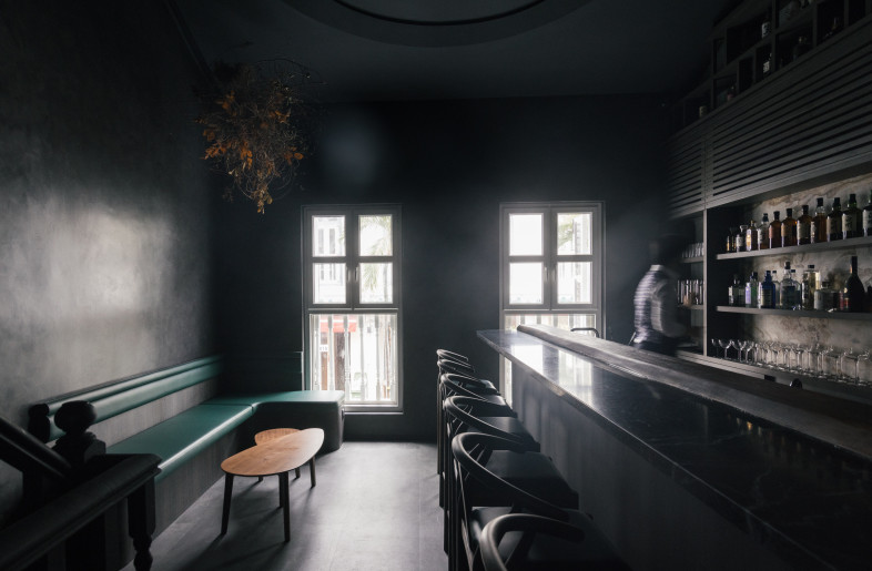 An L-shaped built-in with seating for up to five diners sits in the corner facing the staircase. - Finbarr Fallon