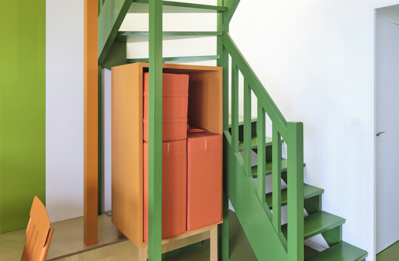 A green staircase leads upstairs. - Philippe Piron