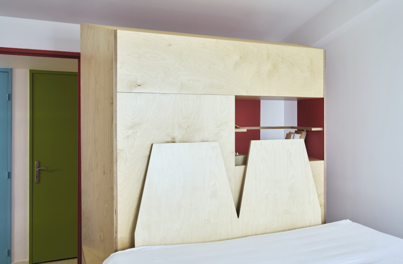 The bedroom space is also positioned atop a wooden platform. - Philippe Piron